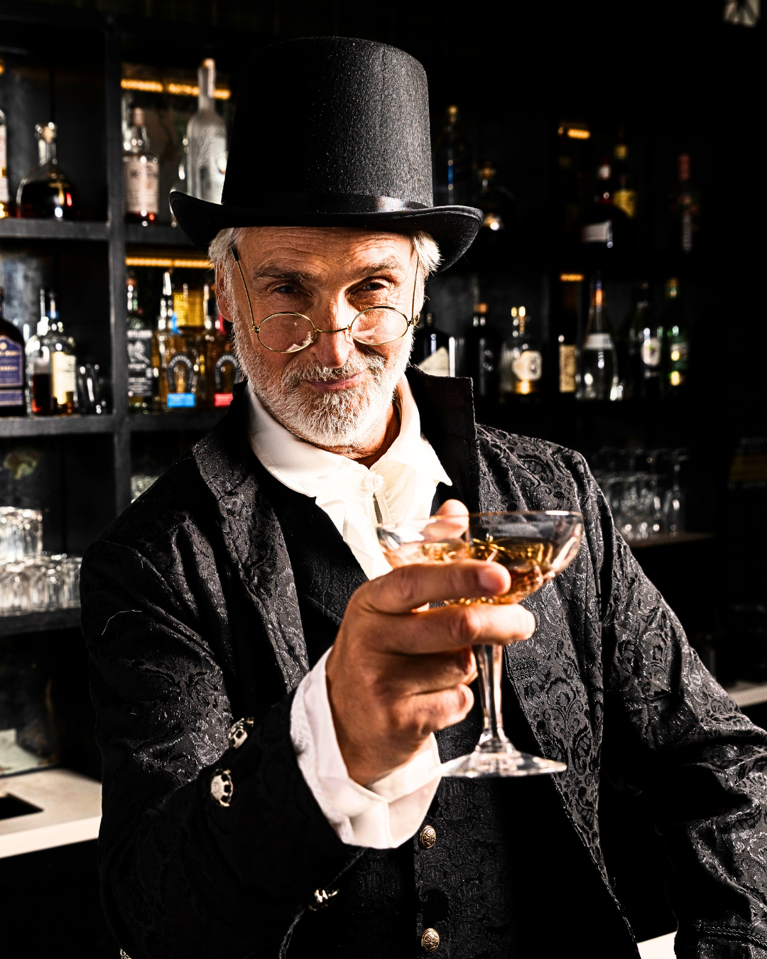 Scrooge at the Drunk Christmas Carol bar waiting with a drink